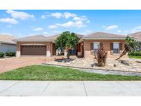 Charming single-story home with a well-manicured lawn, tiled roof, and a two-car garage at 3533 Somerset Cir, Kissimmee, FL 34746