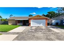 Charming single-story home featuring a two-car garage, a well-manicured lawn, and a classic front facade at 4026 Seabridge Dr, Orlando, FL 32839