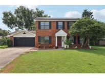 Charming two-story brick home with well-maintained lawn, attached garage, and solar panels at 4536 Misty Morn Cir, Orlando, FL 32812