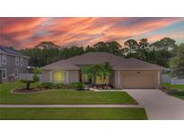Charming single-story home featuring a well-manicured lawn and mature landscaping at 460 Suncrest Ct, Oviedo, FL 32765