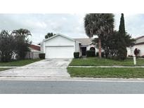 Charming single-story home with a well-maintained lawn and mature landscaping at 5265 Broken Arrow Dr, Kissimmee, FL 34746