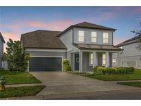 Charming two-story home with well-manicured lawn and inviting front porch with large garage at 840 Livestock Loop, St Cloud, FL 34771