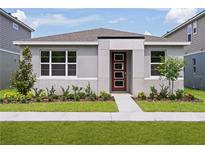 Charming single-story home featuring a modern front door and well-maintained landscaping at 9528 Archway Aly, Orlando, FL 32832