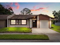 Charming single-story home with well-manicured lawn, neutral paint scheme, and attached one car garage at 999 Mancha Real Dr, Orlando, FL 32807