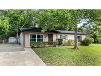 Charming single-story home with well-maintained lawn and mature tree in a peaceful residential neighborhood at 1209 Russell Dr, Ocoee, FL 34761