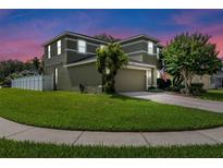 Charming two-story home with a well-manicured lawn and a paved driveway leading to an attached two-car garage at 2850 Spring Heather Pl, Oviedo, FL 32766
