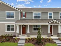 Charming townhome featuring a welcoming porch and well-maintained landscaping at 3279 Gardenia Reserve St, Apopka, FL 32712