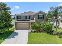 Beautiful two-story home with lush landscaping, attached two-car garage, and inviting curb appeal at 352 Giovani Blvd, Clermont, FL 34715