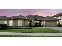 Charming home featuring a tile roof, manicured lawn, and inviting curb appeal, set against a beautiful sunset sky at 3995 Equine Cv, Lake Mary, FL 32746