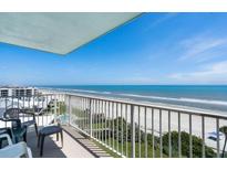 Balcony view of the ocean, sandy beach, and beautiful blue sky, offering a relaxing and scenic outdoor space at 5201 S Atlantic Ave # 703A, New Smyrna Beach, FL 32169