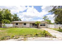 Charming single-story home featuring a well-maintained lawn, tidy landscaping, and a light beige exterior paint at 5300 Locksley Ave, Orlando, FL 32810