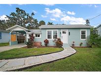 Charming single-story home with a well-manicured lawn, stone walkway, and inviting front entrance at 716 N Rockingham Ave, Tavares, FL 32778