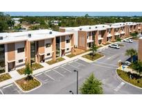 Modern townhouse exteriors with parking, landscaping, and clean architectural lines at 7478 Brooklyn Dr, Kissimmee, FL 34747