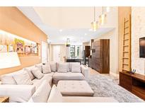 Bright living room with high ceilings, modern lighting, and a comfortable sectional sofa at 7478 Brooklyn Dr, Kissimmee, FL 34747
