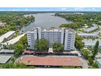 An aerial view of a condo building close to the lake surrounded by trees at 1100 S Orlando Ave # 206, Maitland, FL 32751