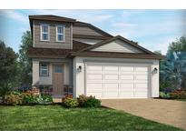 Charming two-story home featuring a two-car garage, stone accents, and a well-manicured lawn at 1856 Archer Dr, Minneola, FL 34715