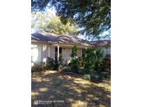 Charming single-story home featuring lush landscaping and mature trees at 2932 Silver Ridge Dr, Orlando, FL 32818