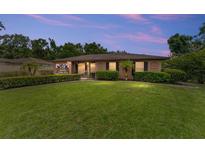 Charming home featuring a lush, manicured front lawn and mature landscaping, creating inviting curb appeal at 316 Amanda Ln, Leesburg, FL 34748