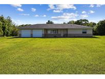 Charming one-story home with attached two-car garage and a spacious, well-maintained lawn at 3226 Midnight Star Ct, Kissimmee, FL 34744