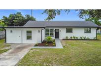 Charming single-story home featuring a freshly painted exterior, new landscaping, and a welcoming front entrance at 609 Brockway Ave, Orlando, FL 32807