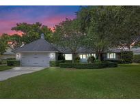 Charming single-story home with lush landscaping, mature trees, and a two-car garage at 641 Virginia Dr, Winter Park, FL 32789