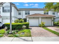 Well maintained home exterior featuring an attached two car garage and manicured landscaping at 6931 Sperone St, Orlando, FL 32819