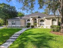 Charming single-story home featuring a beautifully landscaped front yard at 704 Forest View Ct, Winter Springs, FL 32708