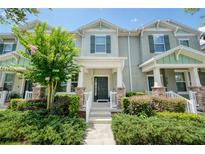 Inviting two-story townhouse with fresh landscaping and a welcoming front porch at 8164 Wood Sage Dr, Winter Garden, FL 34787