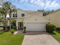 Charming two-story home with a well-maintained lawn and a brick paved driveway at 9031 Stonebury Way, Orlando, FL 32832