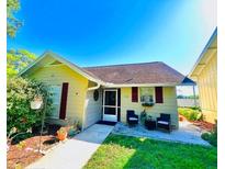 Charming single-story home with a cozy front porch, lush landscaping, and inviting curb appeal at 1034 Villa Ln # 18, Apopka, FL 32712