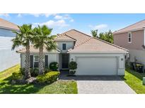 Charming single-Gathering home with well-manicured landscaping and a two-car garage with beautiful clay tile roof at 1111 Oak Bluff Dr, Davenport, FL 33837