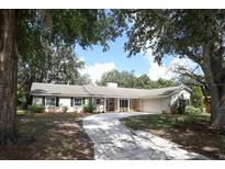 Charming ranch-style home with a landscaped front yard and a winding stone driveway at 1481 Glastonberry Rd, Maitland, FL 32751