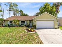 Charming single-story home with well-manicured lawn, a front yard, and a two car garage at 204 Grovepark Dr, Davenport, FL 33837
