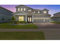 Charming two-story home featuring a three-car garage and beautifully landscaped front yard at 3179 Sailing Pier Ave, Winter Garden, FL 34787