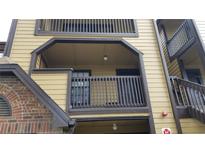 A tan apartment building with dark brown trim and railings, and a brick accent wall on the bottom left at 420 Forestway Cir # 202, Altamonte Springs, FL 32701