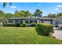 Charming single-story home featuring a well-manicured lawn and lush, trimmed hedges, creating a welcoming curb appeal at 811 Oregon St, Orlando, FL 32803