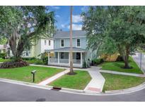 Charming two-story home featuring a quaint front porch and well-maintained landscaping in a peaceful neighborhood setting at 1021 S Elm Ave, Sanford, FL 32771