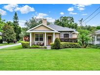 Charming home featuring manicured lawn, neutral colors, and decorative stone accents at 2009 E Grant St, Orlando, FL 32806
