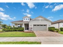 Charming single-story home with manicured lawn, brick driveway, and two-car garage at 2066 Cresswell St, Ocoee, FL 34761