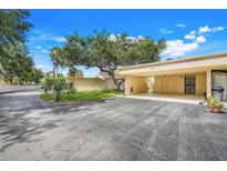 Charming carport and driveway featuring mature landscaping in a well-maintained neighborhood at 208 Sonora Drive # 208, Casselberry, FL 32707