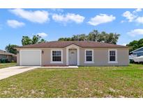 Charming single-story home featuring a well-maintained lawn and attached one-car garage at 3313 Buckland St, Deltona, FL 32738