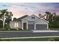 Charming two-story home with stone accents, a three-car garage and manicured landscaping at 3492 Lemon Button Ter, Apopka, FL 32712