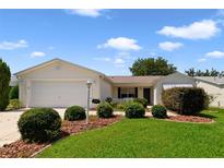 Charming one-story home featuring a well-maintained lawn, attractive landscaping, and a classic exterior design at 3531 Reston Dr, The Villages, FL 32162