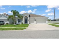 Charming single-Gathering home with a well-manicured lawn, complemented by a convenient two-car garage and a beautiful palm tree at 3866 Cabo Rojo Dr, St Cloud, FL 34772