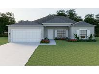 Charming single-story home features a two-car garage, landscaped yard, and a welcoming front entrance at 5381 Sw 128Th Street Rd, Ocala, FL 34473