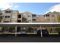 Apartment building with multiple stories and covered parking at 6434 Cava Alta Dr # 401, Orlando, FL 32835