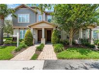 Charming townhome featuring a well-manicured lawn and a welcoming front entrance, enhancing its curb appeal at 11686 Water Run Aly, Windermere, FL 34786