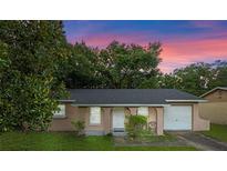 Charming single-story home with stucco exterior, arched entry, and attached one-car garage at 2843 Grove Dr, Sanford, FL 32773