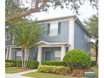 Charming two-story townhouse with a well-manicured lawn and lush landscaping at 3321 Wilshire Way Rd # 6, Orlando, FL 32829