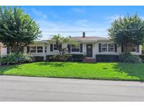Charming single-story home with a manicured lawn, mature trees, and blooming hydrangeas, creating beautiful curb appeal at 600 Sheridan Blvd, Orlando, FL 32804